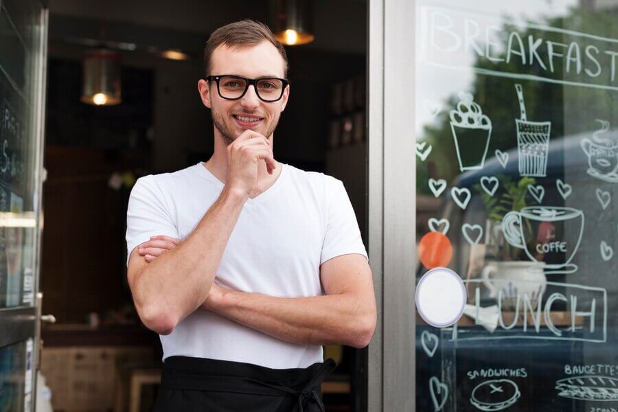 portrait smiling male waiter outside cafe 329181 2058