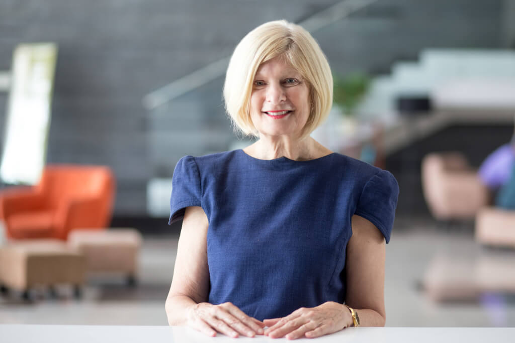 smiling woman waiting hotel receptionist scaled