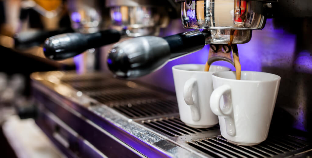 Two espresso cups with espresso machine