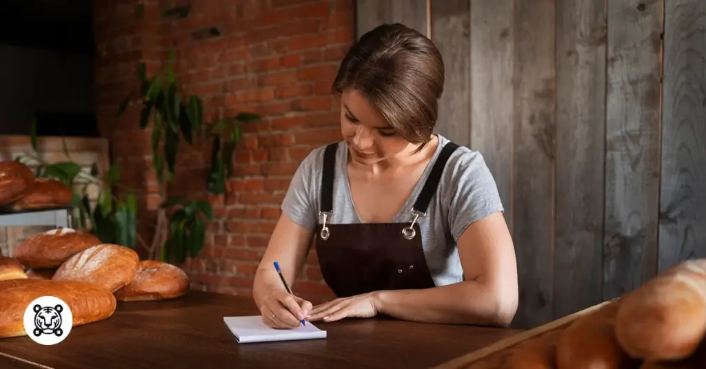 female baker writing on a paper